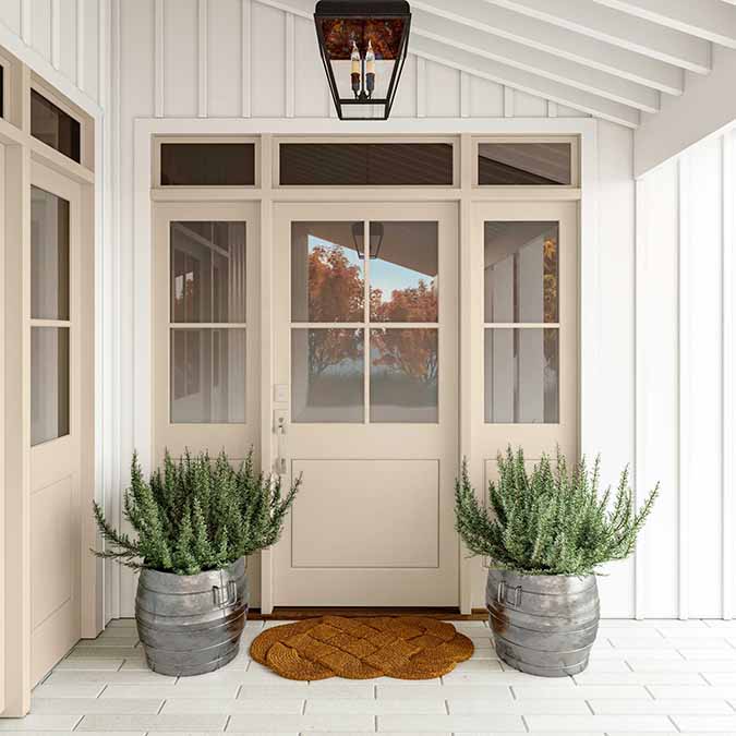 A residential home exterior in the house paint color Turbinado, the perfect warm beige paint color from Clare. Turbinado is a true, warm tan paint color paint color reminiscent of honey colored sugar crystals. Shop now.