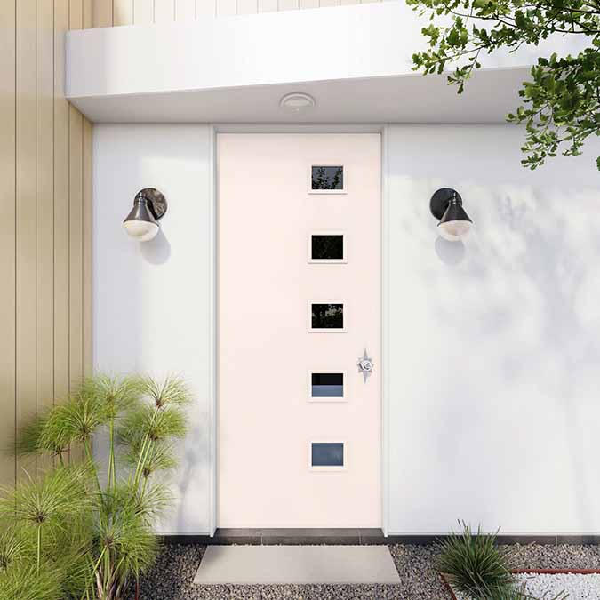 A residential home exterior in the house paint color Wing It, the perfect best light pink paint color from Clare. Wing It is a sophisticated pale pink paint color and a best-seller that's versatile enough to feel like a neutral. Shop now.