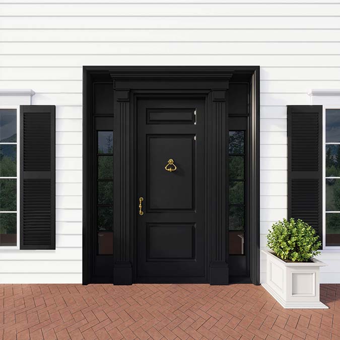 A residential home exterior in the house paint color Blackest, the perfect black paint from Clare. Blackest is a deep, dramatic black paint color with the power to make a space pop. Shop now and get premium, zero VOC paint delivered to your door.