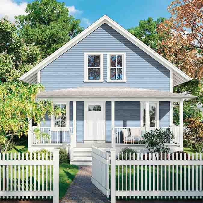A residential home exterior in the house paint color Cloud Watching, the perfect peaceful blue from Clare. Cloud Watching is a peaceful blue paint color. Like looking up at a perfect sky on a balmy summer day, it’s guaranteed to lift your space higher. Shop now.