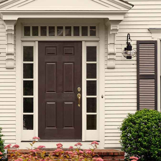 A residential home exterior in the house paint color Coffee Date, the perfect coffee brown paint color from Clare. Coffee Date is a rich, coffee brown paint color. Like a bold, complex dark roast, this color is sure to spark a conversation! Shop now.