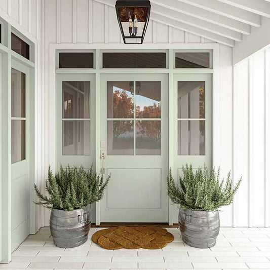 A residential home exterior in the house paint color Dirty Martini, the perfect olive green paint color from Clare. Dirty Martini is a stunning, light olive green paint color. This cloudy olive green classic makes a sophisticated statement in any room.  Shop now.