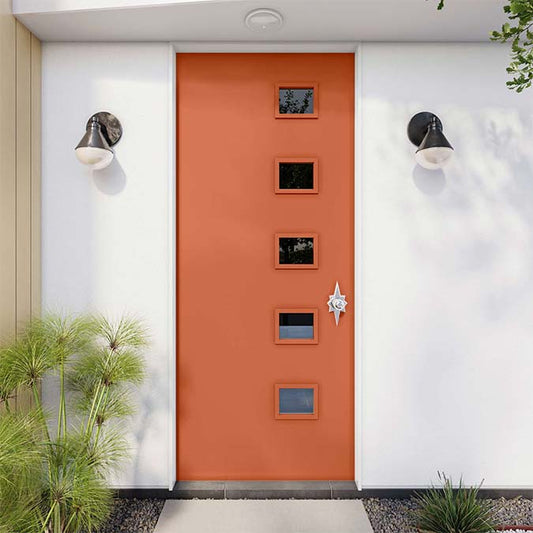 A residential home exterior in the house paint color Fire Sign, the perfect orange paint color from Clare. Fire Sign is a bold, vivacious orange paint color that brings the heat in any room where you want to make a daring design move. Shop Now