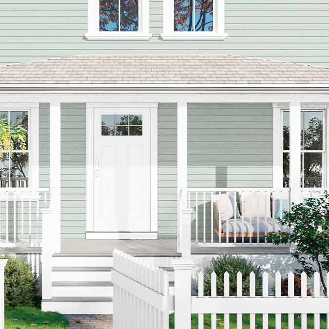 A residential home exterior in the house paint color Fresh Kicks, the perfect bright white paint color from Clare. Fresh Kicks is a clean, bright white paint color with no undertones. Fresh and modern, like your favorite white pair, straight out the box. Shop now.