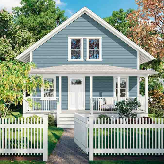 A residential home exterior in the house paint color Good Jeans, the perfect denim blue paint color from Clare. Good Jeans is a sophisticated blue paint color with a hint of gray undertones. Just as perfect as your favorite pair of broken-in denim. Shop now.