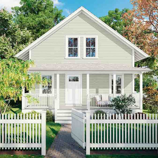 A residential home exterior in the house paint color Greenish, the perfect light green paint color from Clare. Greenish is a light green paint color that adds just the right dose of freshness to any space. Try it as an alternative to traditional neutrals.