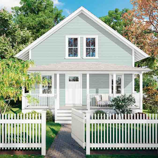 A residential home exterior in the house paint color Headspace, the perfect blue green paint color from Clare. Headspace is a soft, blue-green paint color that brings a calm, airy feel to any room. This popular shade of blue is a best-seller and fan- favorite! Shop now.