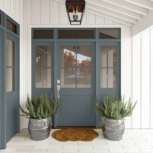 A residential home exterior in the house paint color Irony, the perfect dark gray paint color from Clare. Irony is our deepest, darkest gray paint color inspired by the color of iron, this dark gray color evokes richness and drama.  Shop now.