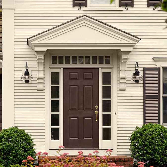 A residential home exterior in the house paint color Like Buttah, the perfect cream paint color from Clare. Like Buttah is the perfect cream paint color. This warm, buttery beige adds a rich boost of flavor to any room you roll it in.