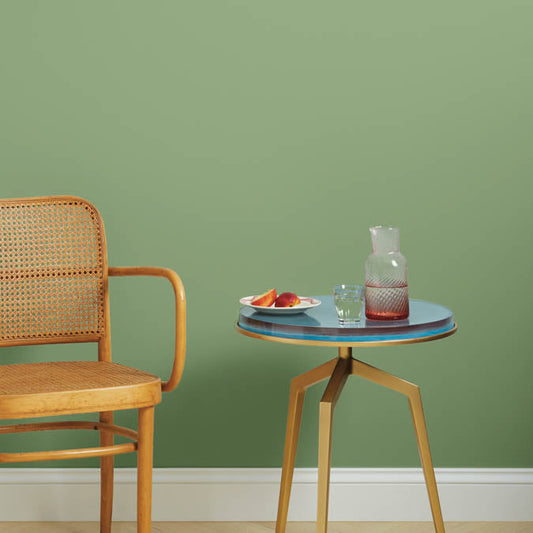 A beautiful home interior room painted in Avocado Toast, the perfect avocado green paint color from Clare. Avocado Toast is a medium green paint color with a fresh, natural vibe. Just like avocados! Shop now and get premium, zero VOC paint delivered. Shop now!