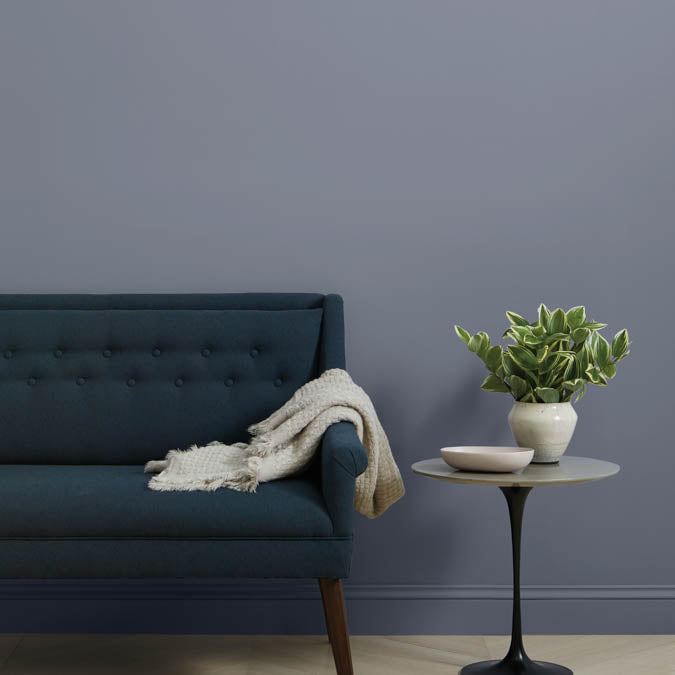 A beautiful home interior room painted in Cosmic Vibes, the perfect purple paint color from Clare. Cosmic Vibes is a mysterious medium dusty purple paint color that feels straight out of the Milky Way.  Shop now.