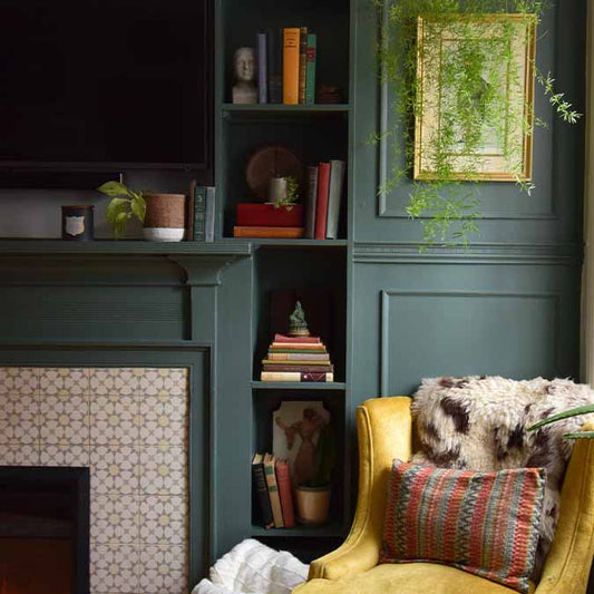 A beautiful home interior room painted in Current Mood, the perfect green interior paint color from Clare. Current Mood is a deep, moody green paint color for those who aren't afraid to bring the drama. This bold, dark green is both intense and alluring. Shop now.