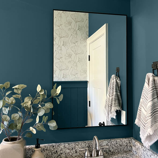 A beautiful home interior room painted in Deep Dive, the perfect dark ocean blue paint color from Clare. Deep Dive is a dark, deep-sea inspired blue paint color that's bold and sophisticated with a hint of green undertones. Shop now.