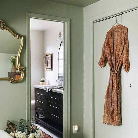 A beautiful home interior room painted in Dirty Martini, the perfect olive green paint color from Clare. Dirty Martini is a stunning, light olive green paint color. This cloudy olive green classic makes a sophisticated statement in any room.  Shop now.