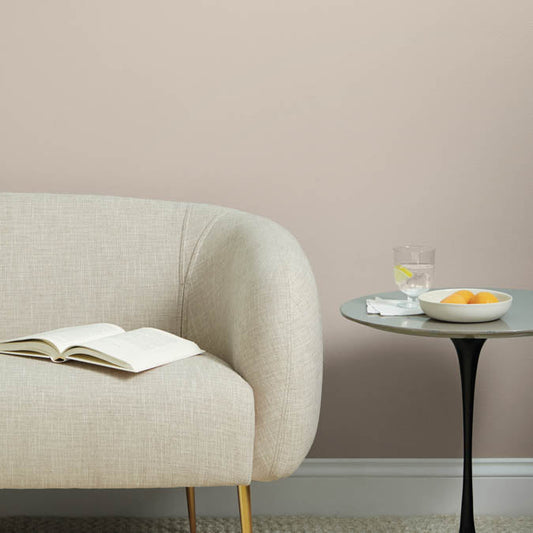 A beautiful home interior room painted in Flatiron, the perfect taupe paint color from Clare. Flatiron is a rich, warm, neutral paint color that plays beautifully with natural light and is inspired by the namesake neighborhood in downtown NYC. Shop now.