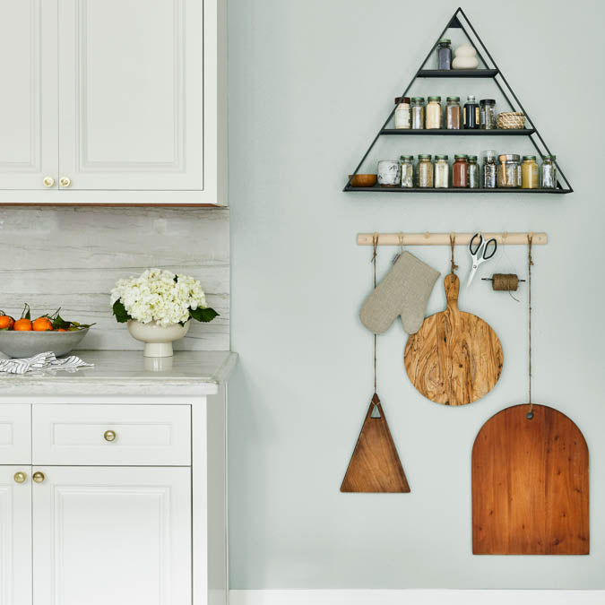 A beautiful home interior room painted in Grayish, the perfect gray with green paint color from Clare. Grayish is a light gray paint color with obvious green undertones. Works wonders in open, airy spaces.  Shop now.