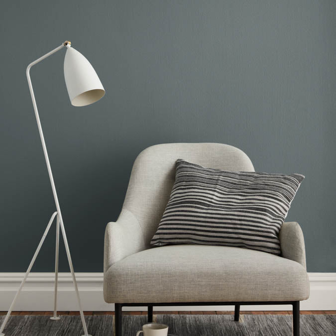 A beautiful home interior room painted in Irony, the perfect dark gray paint color from Clare. Irony is our deepest, darkest gray paint color inspired by the color of iron, this dark gray color evokes richness and drama.  Shop now.
