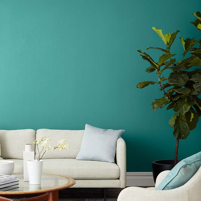 A beautiful home interior room painted in Keep It Teal, the perfect teal paint color from Clare. Keep It Teal is a striking teal paint color with the perfect amount of punch. Bring in a burst of color with this lively green-blue hue. Shop now.