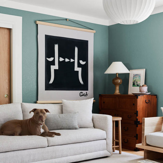 A beautiful home interior room painted in Make Waves, the perfect grayish blue-green paint color from Clare. Make Waves is a versatile greenish-blue paint color that's serene, sophisticated and nuanced, like ocean waves rippling under the sun. Shop now.