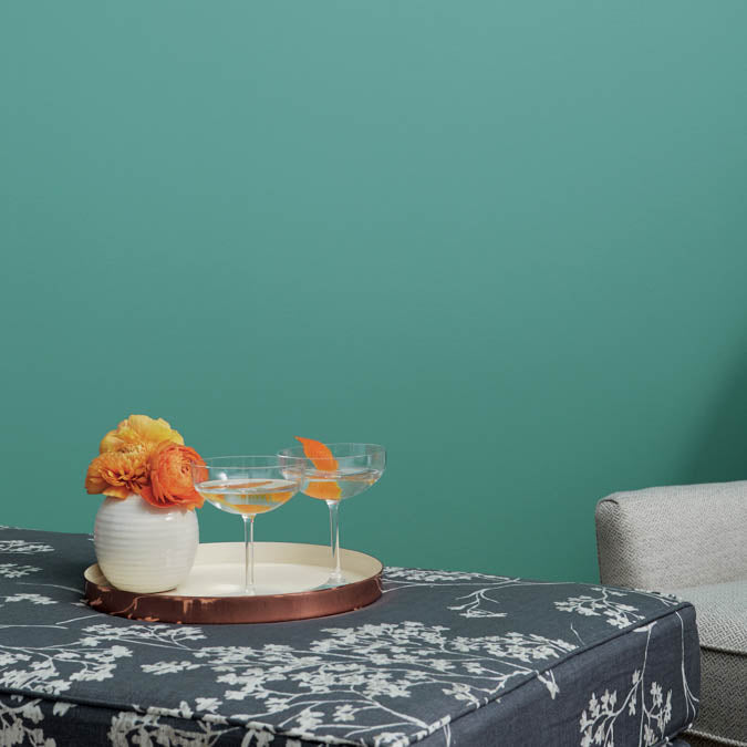 A beautiful home interior room painted in Vacay, the perfect tropical green paint color from Clare. Vacay is a vibrant blue-green  paint color with tropical vibes that feels like a permanent vacation. Shop now.