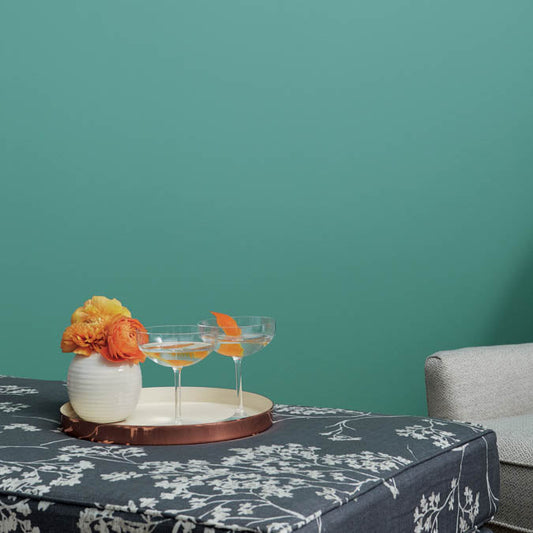 A beautiful home interior room painted in Vacay, the perfect tropical green paint color from Clare. Vacay is a vibrant blue-green  paint color with tropical vibes that feels like a permanent vacation. Shop now.