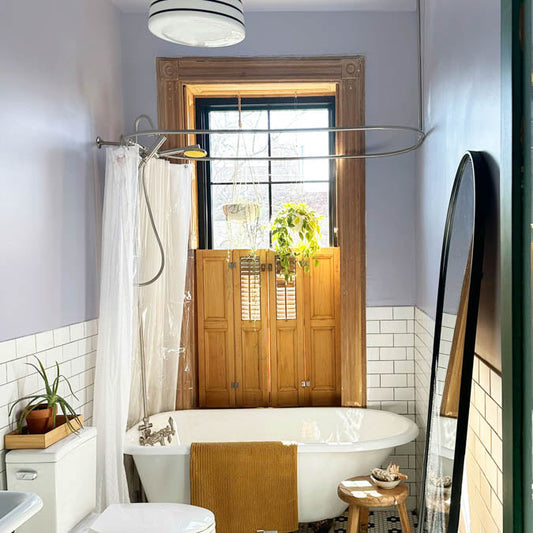 A beautiful home interior room painted in Wink, the perfect periwinkle light purple paint color from Clare. Wink is a soft purple-ish paint color that's like periwinkle, but a little more muted, and is sure to brighten up any space! Shop now.